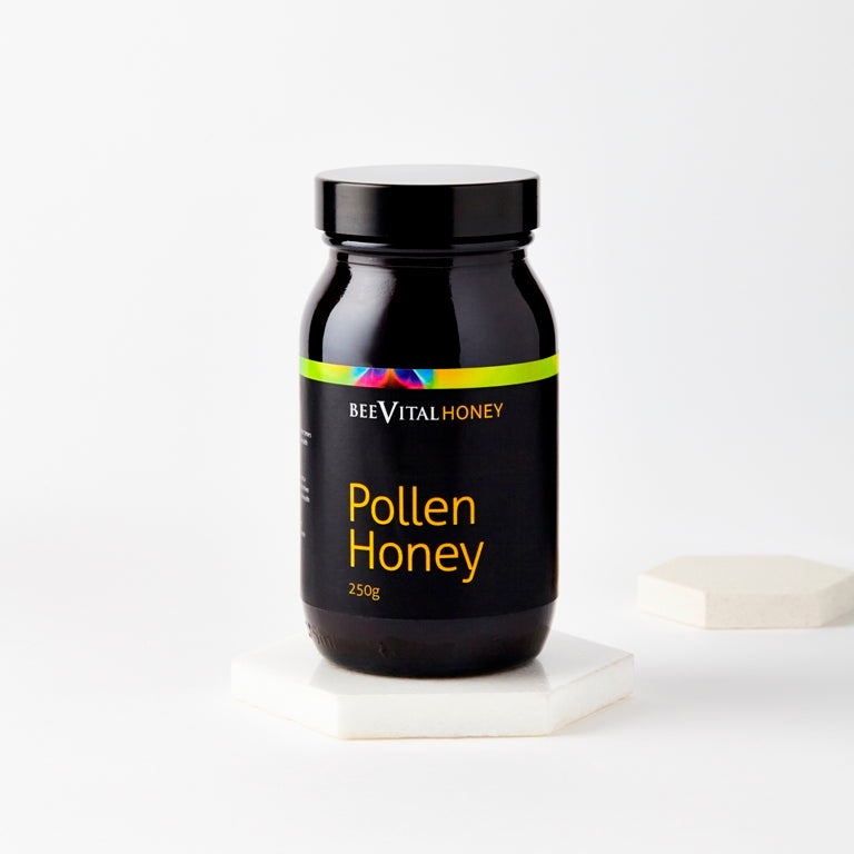 A black 250g jar of BeeVital Pollen Honey on a white background.
